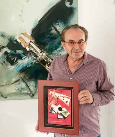 Sergei with Lark's Collage from his Collection And Kiki's art work in the Background
